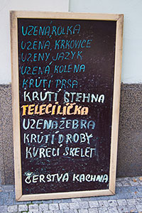 A sign in front of a Prague butcher shop